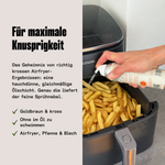 Hand sprüht OYL Air Fryer Spray als feinen Ölnebel über goldbraune Pommes im Airfryer-Korb